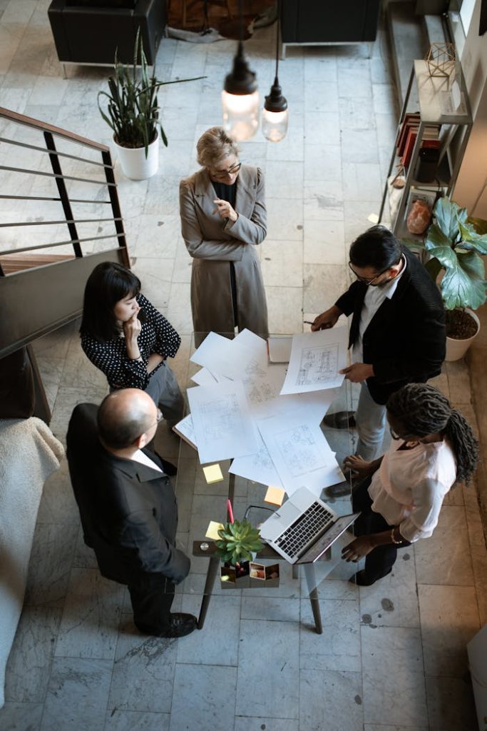 A team of professionals engage in a business meeting in a sleek, modern office setting.